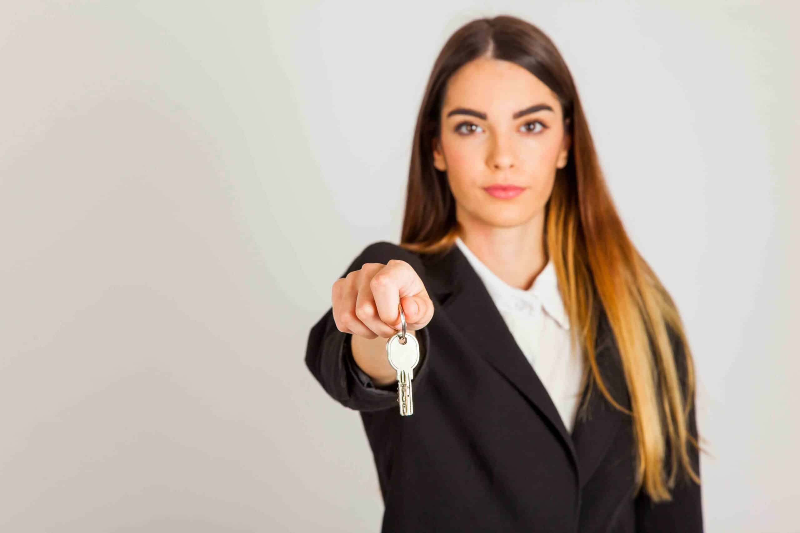 professional woman giving keys scaled